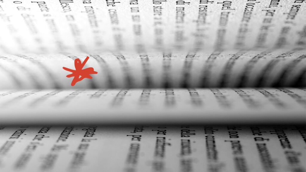 Pages in a book on its side with blurry words.-1