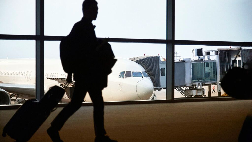 Shadow of man walking in airport