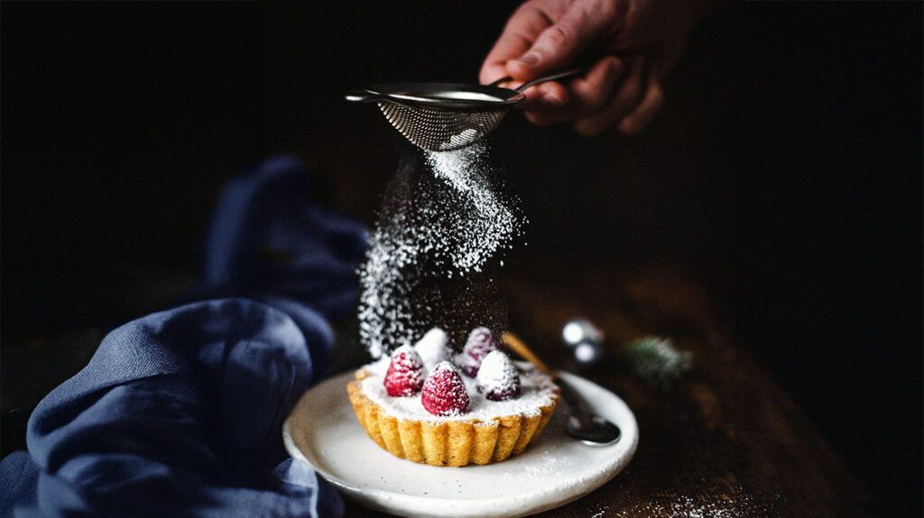 Custard pastry with raspberries and sifting powdered sugar