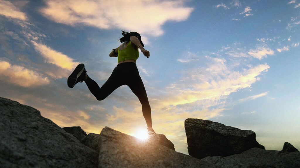 Person running, set against a sunrise
