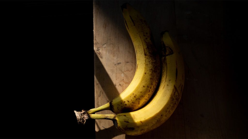 A bunch of bananas in a dark room