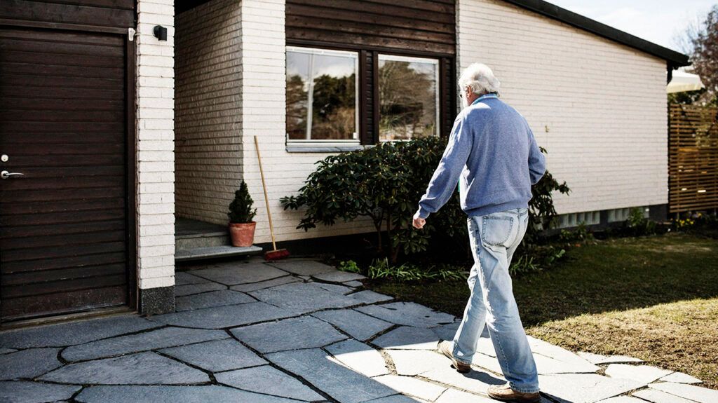A person walking towards a house 1