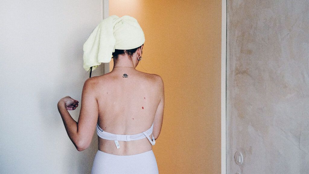 rear view of a young woman with a towel on her head-1