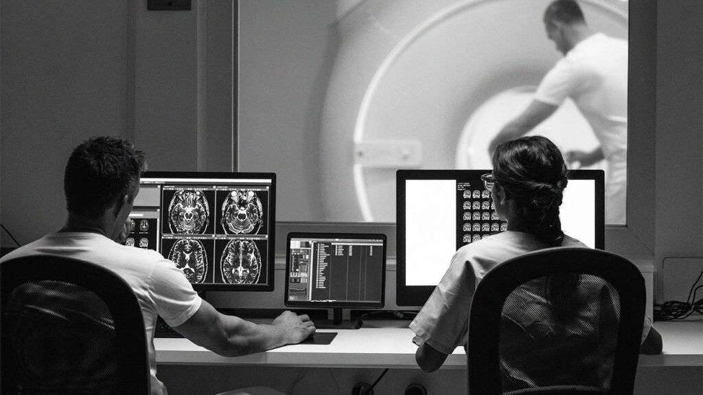 Two MRI radiologists looking at the results of an MRI scan.