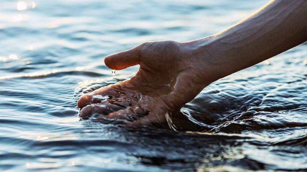 a hand touching water-1