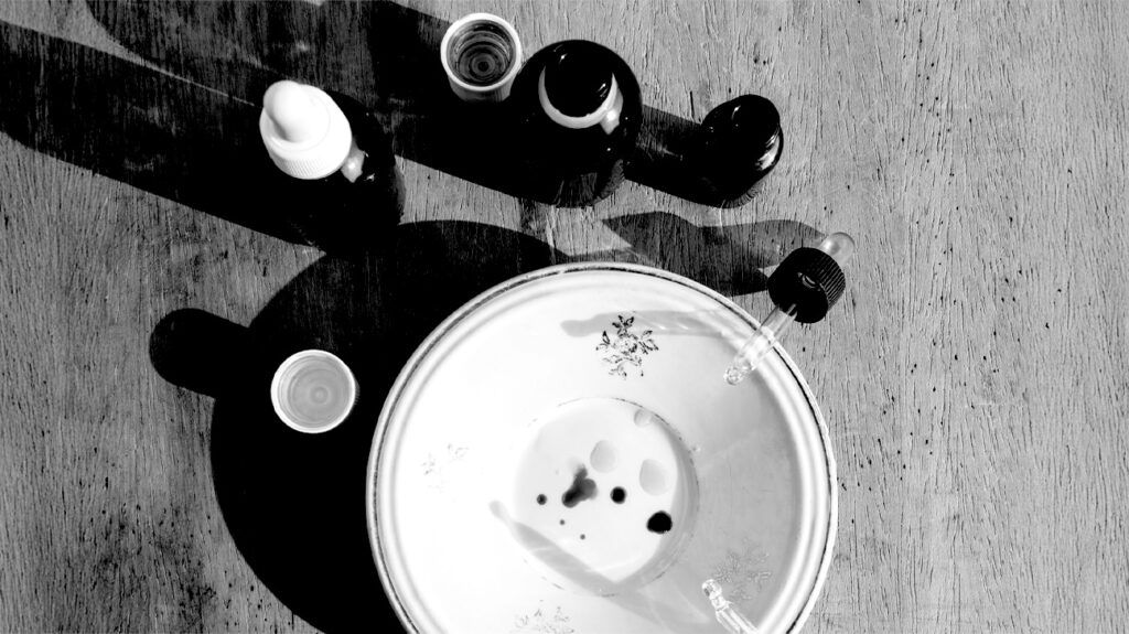 Jars of essential oils next to a plate.-1