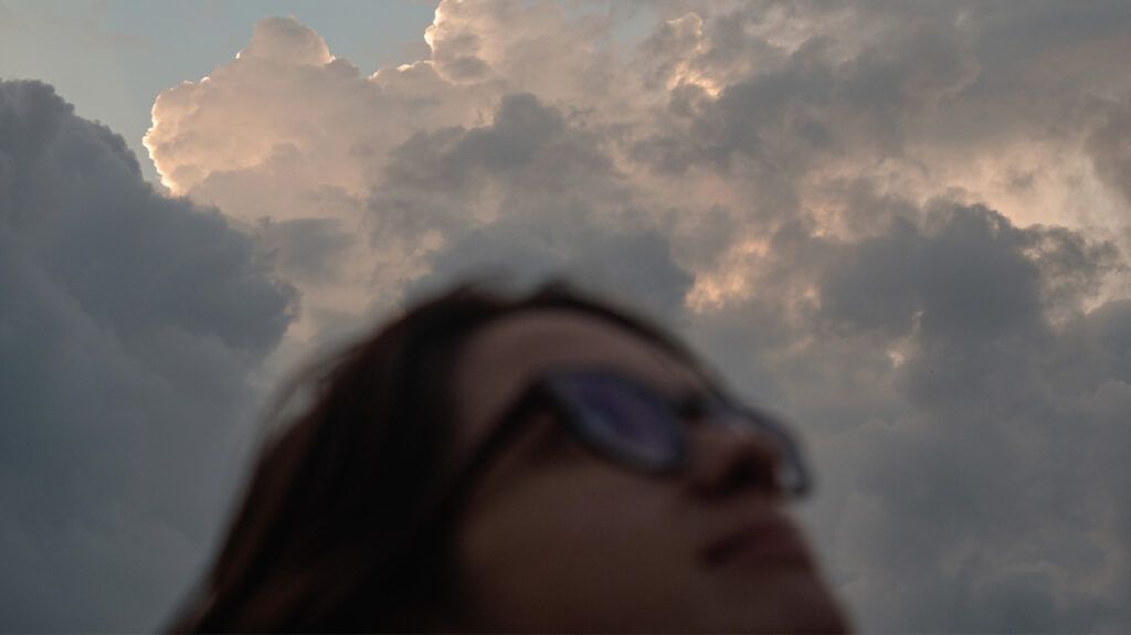 a person looking up at the clouds