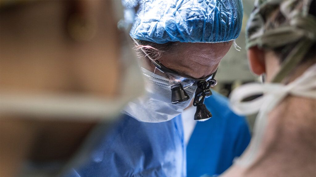 Surgeon with head lamp on