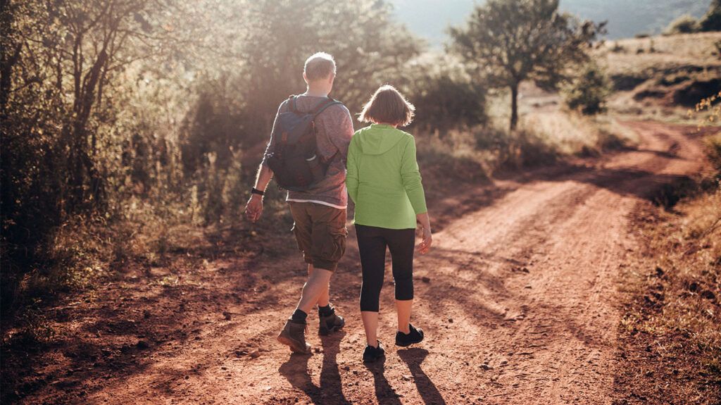Two people walking on a trail 1