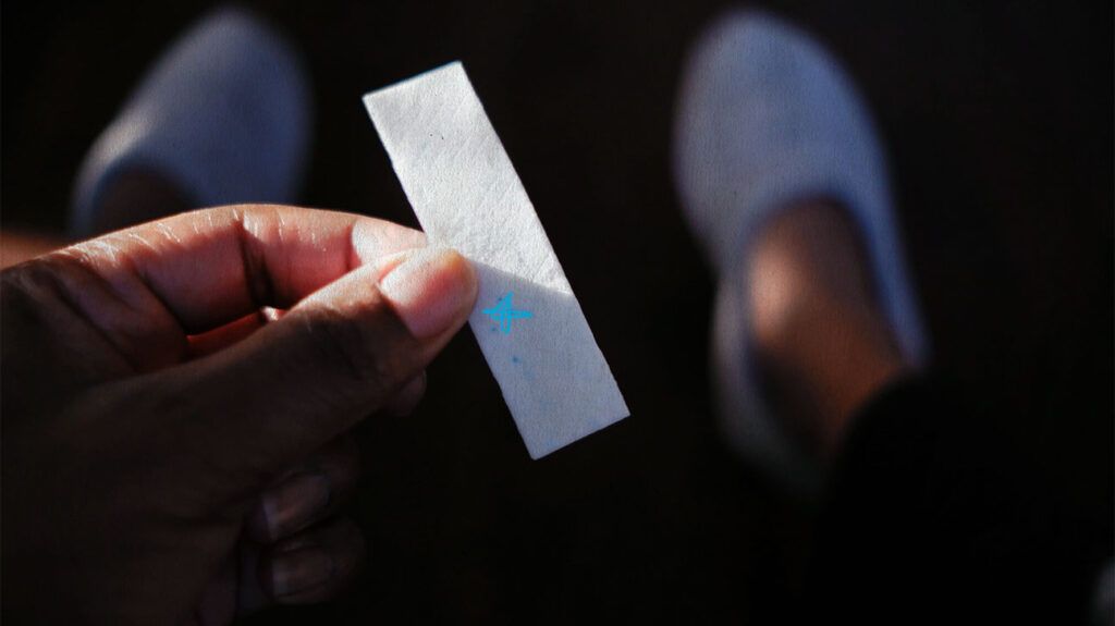 fingers holding a stick of gum-1
