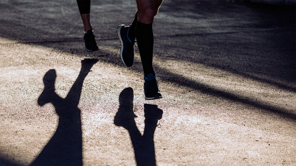 Feet of Two Men Running on The City Street. -2
