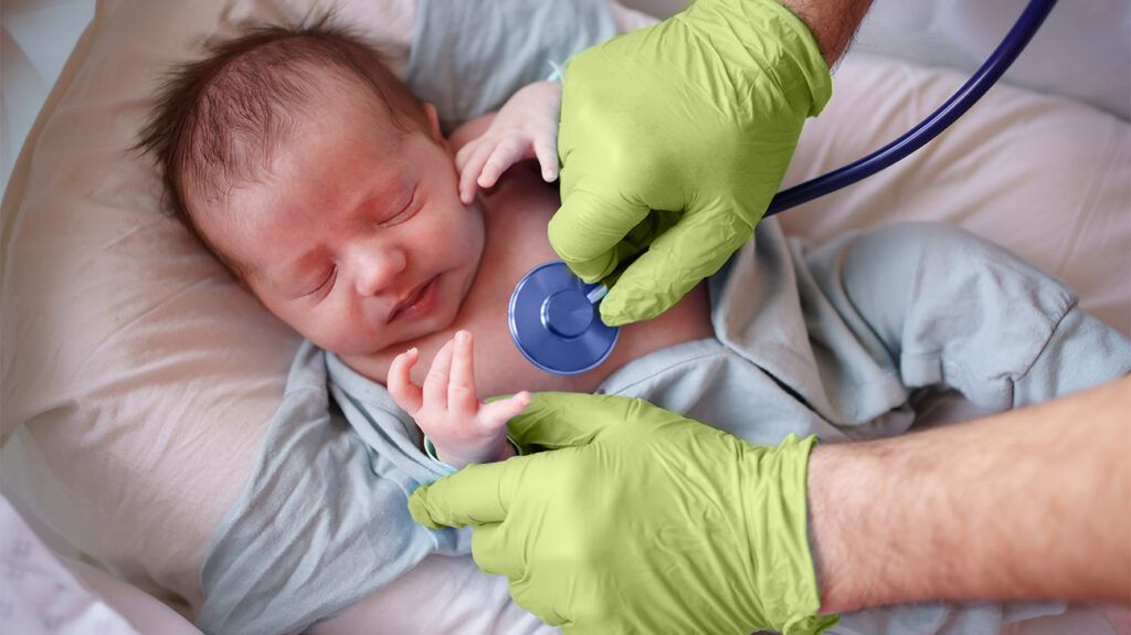 A doctor placing a stethoscope on a baby's chest
