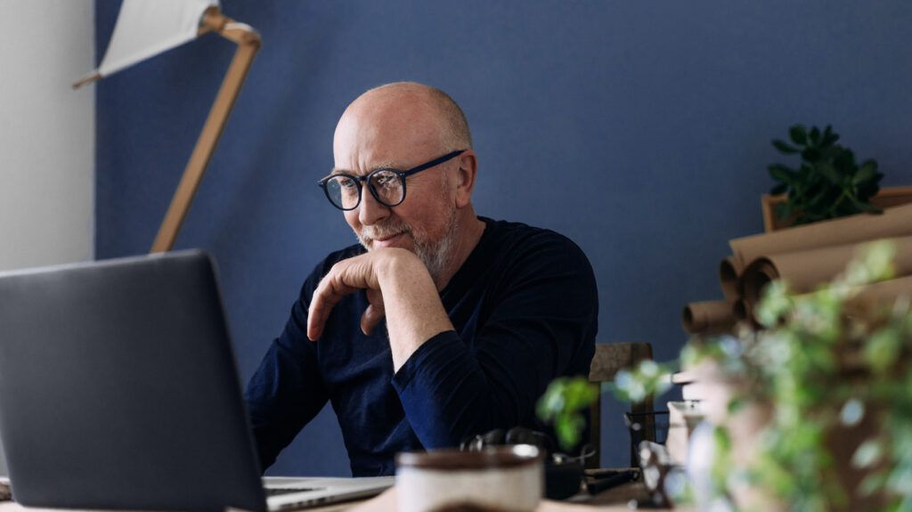 A man sitting at a computer.-1
