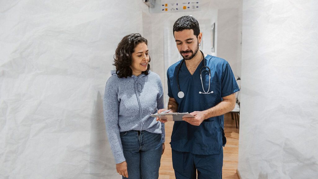 A healthcare professional talking to a person 1