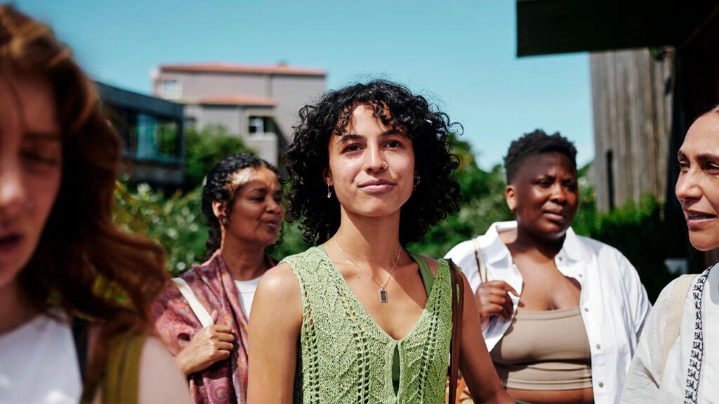 A person standing in a crowd outside.-2