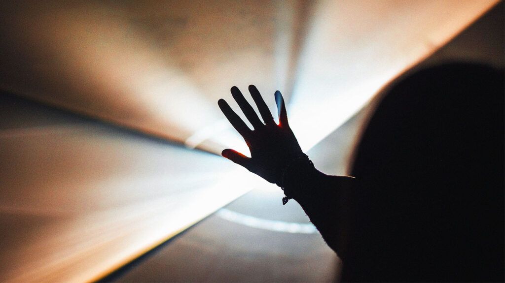 Open hand on abstract background of light