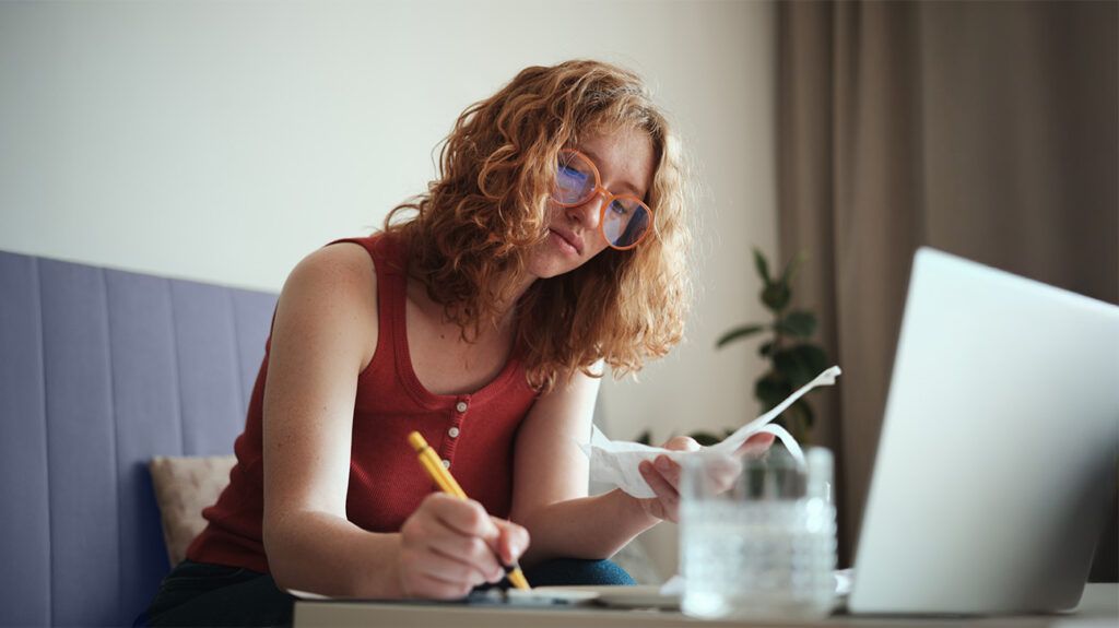 A young adult signing paperwork-1.