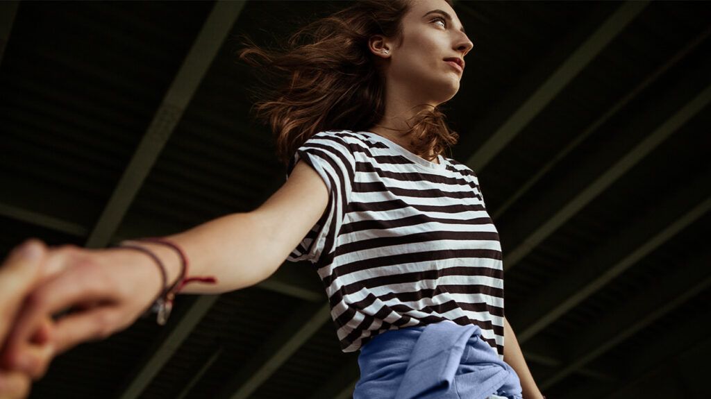 A person with arms out, looking disconnected