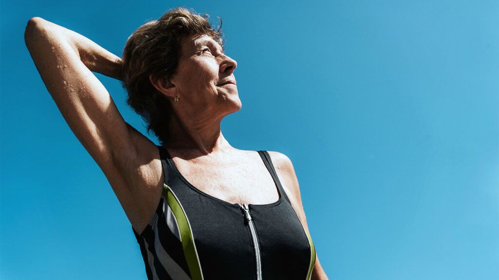 older white woman in swimsuit looking up to the sky