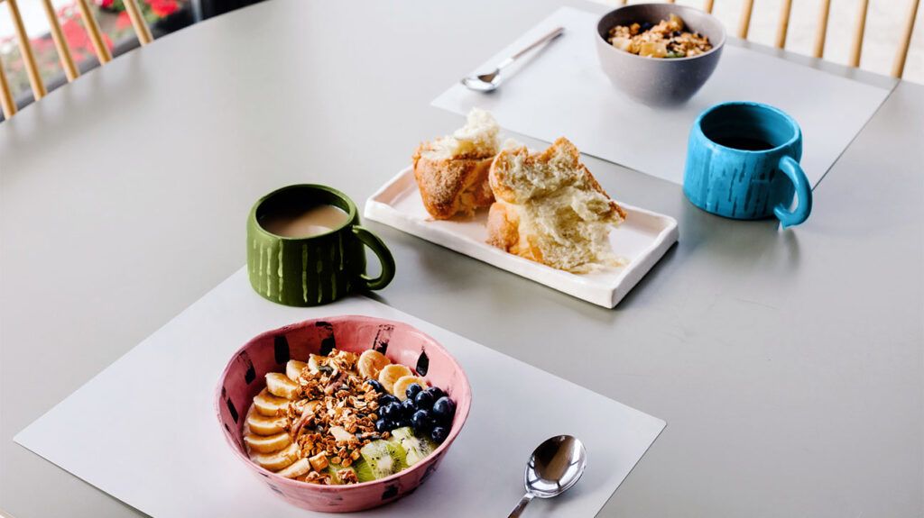 breakfast fruit bowl, coffee, and sweet buns