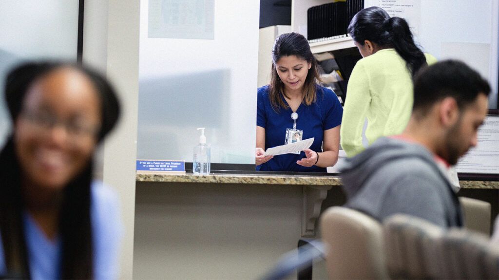 People in a medical centre reception area 1