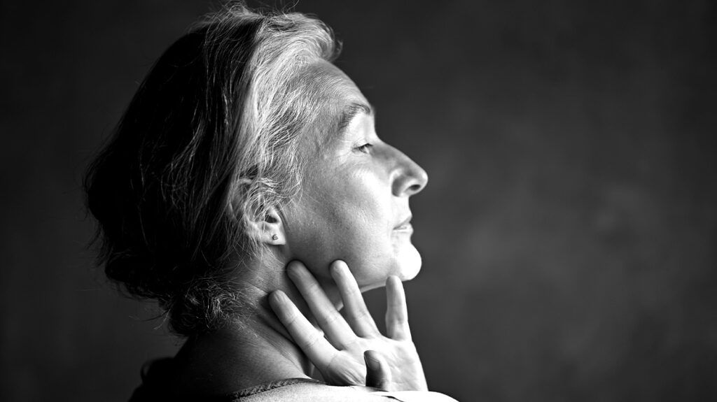 A person touching their neck 1