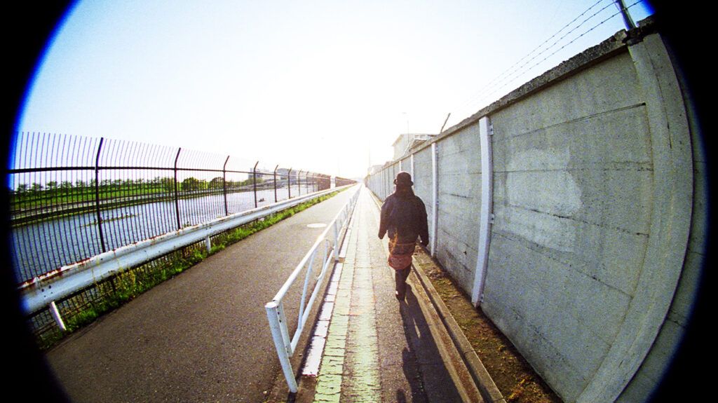 person seen through a concave lens while on a riverside walk