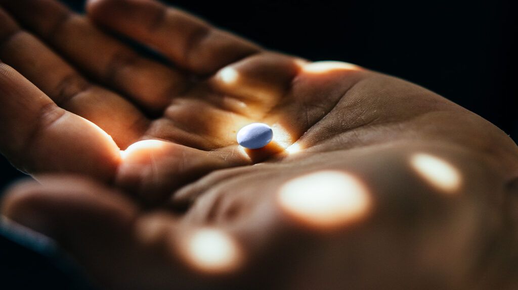 small pill on someone's hand