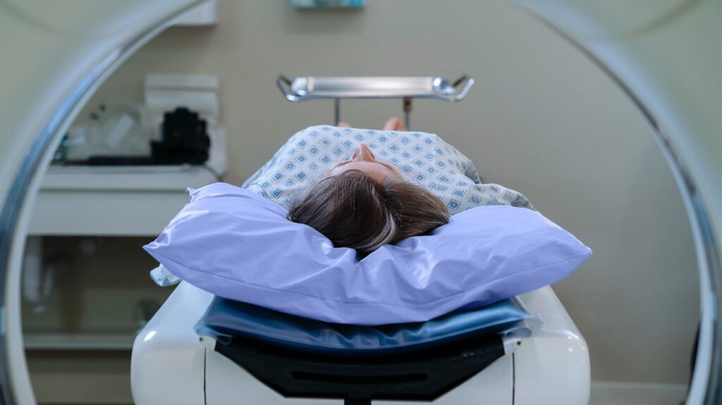 A person laying down as they wait to be scanned via an MRI machine