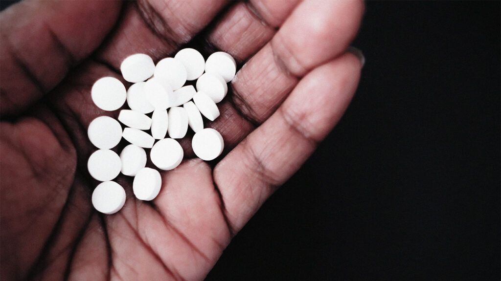 white melatonin tablets on someone's palm