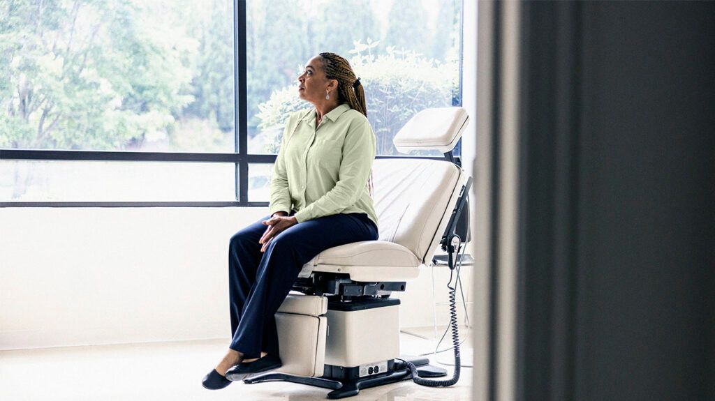 Female patient waiting in doctor's exam room