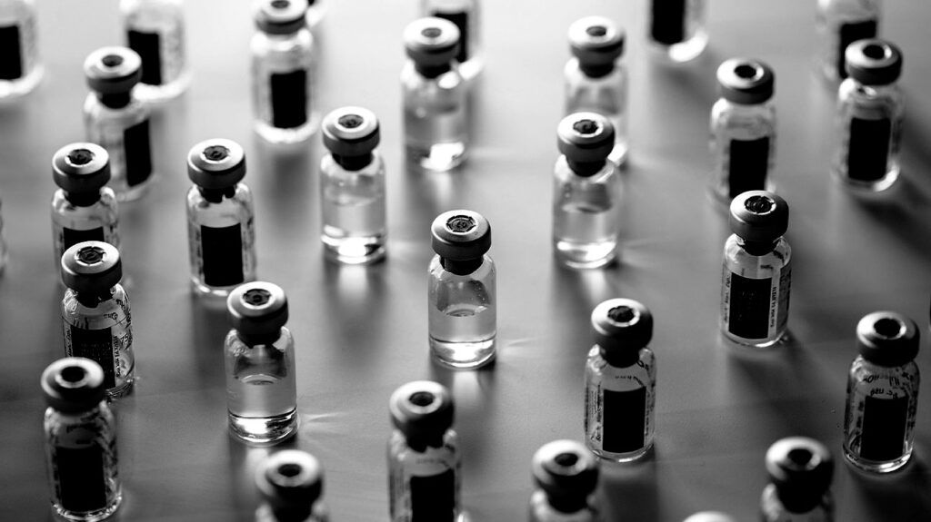 Black and white image of vaccine vials.