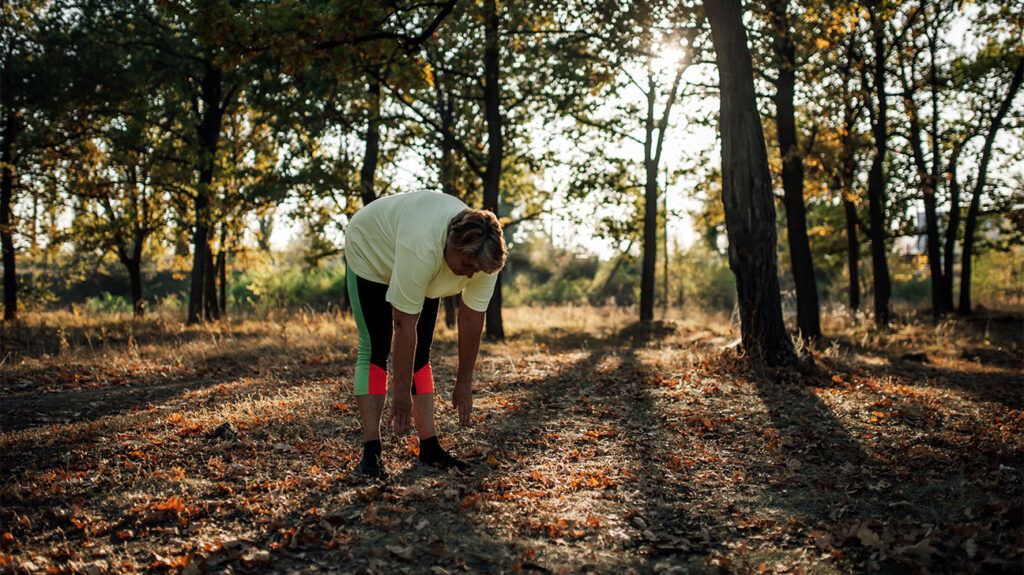 older person exercising in park