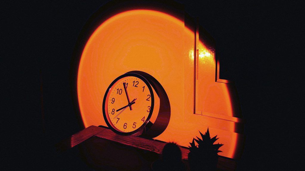 A wall clock on an office desk.