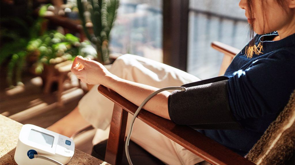 woman measuring her blood pressure