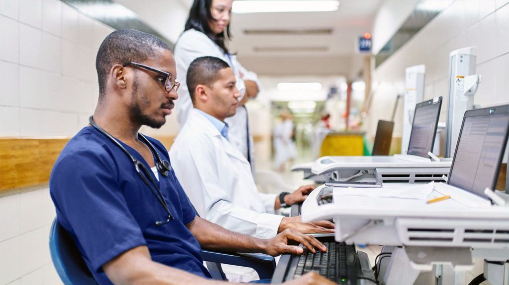 Healthcare professionals working on computers.