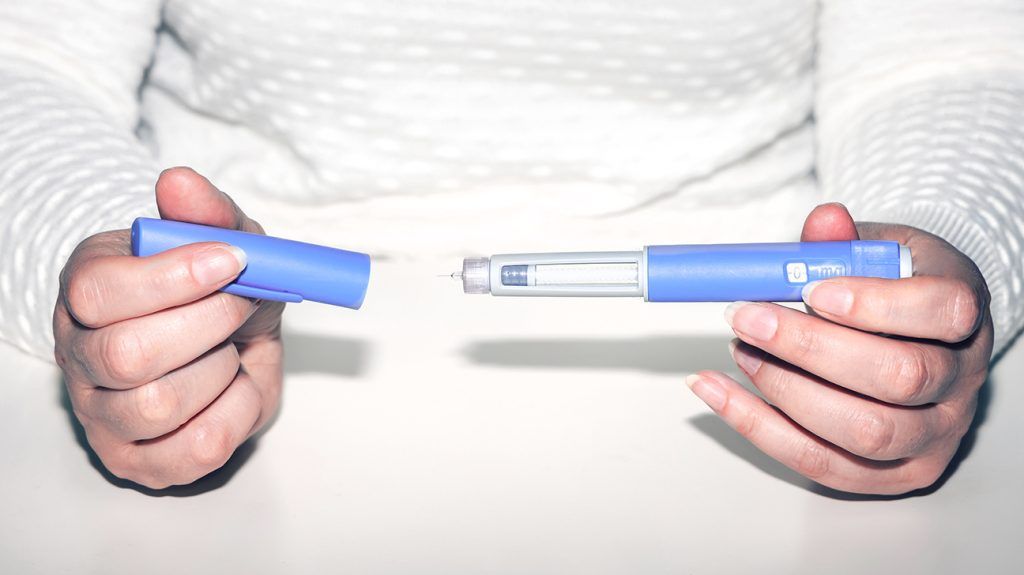 hands holding dose of injectable GLP-1