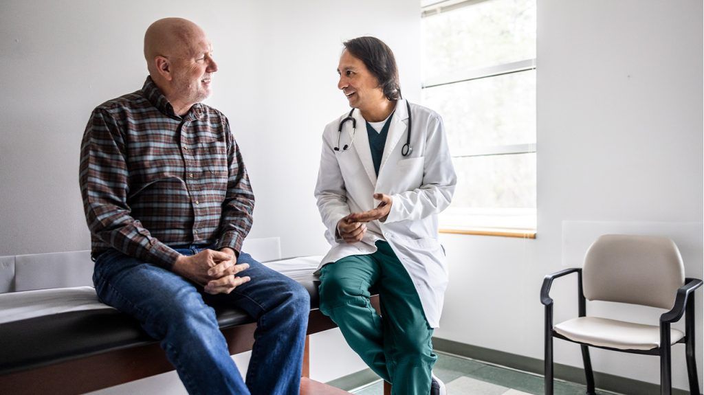An older male speaking with a doctor.