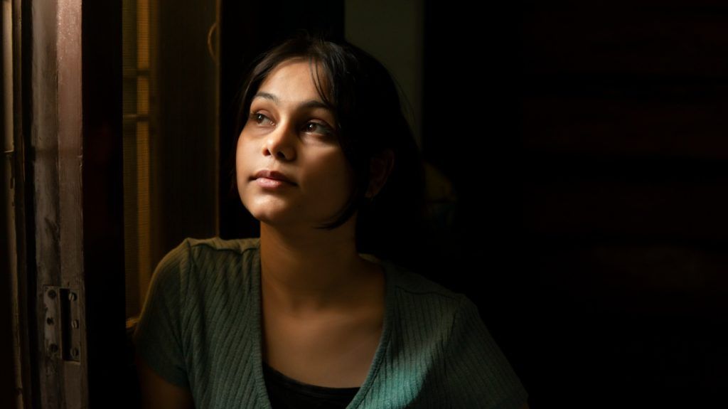 candid portrait of contemplative South Asian woman