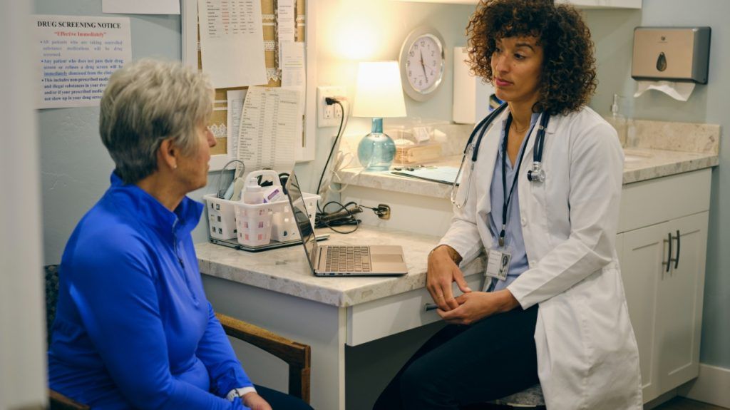 A medical professional is speaking with a patient.