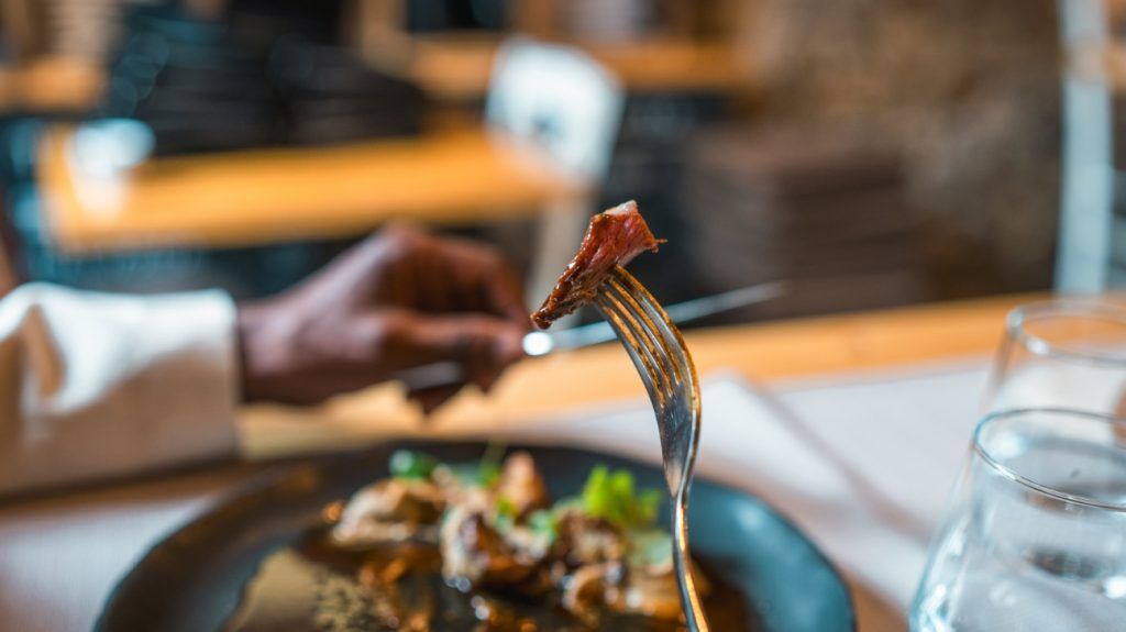 A person eating steak.