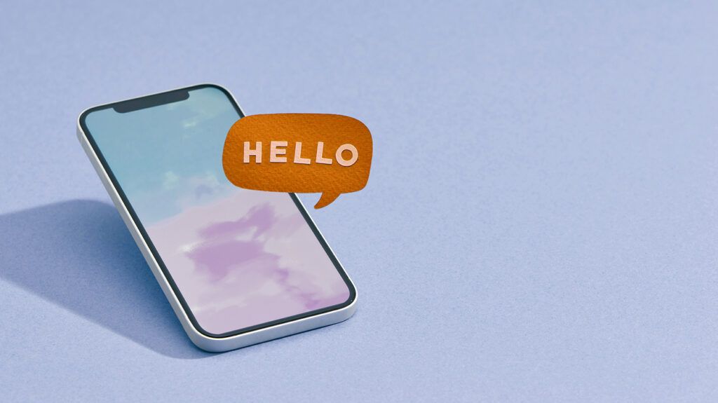 smartphone on blue background with a hello text bubble