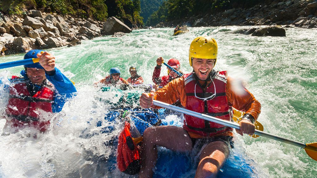 Group of people extreme rafting