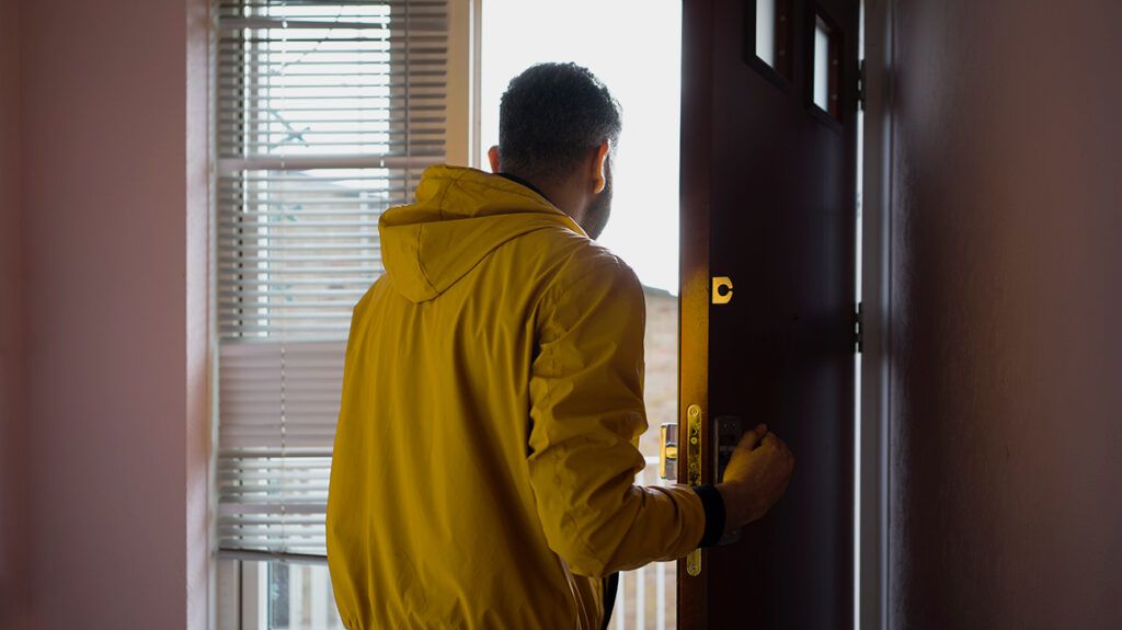 Man stepping out of a house