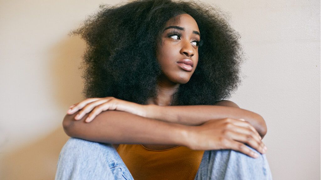 young black woman looking pensive and anxious