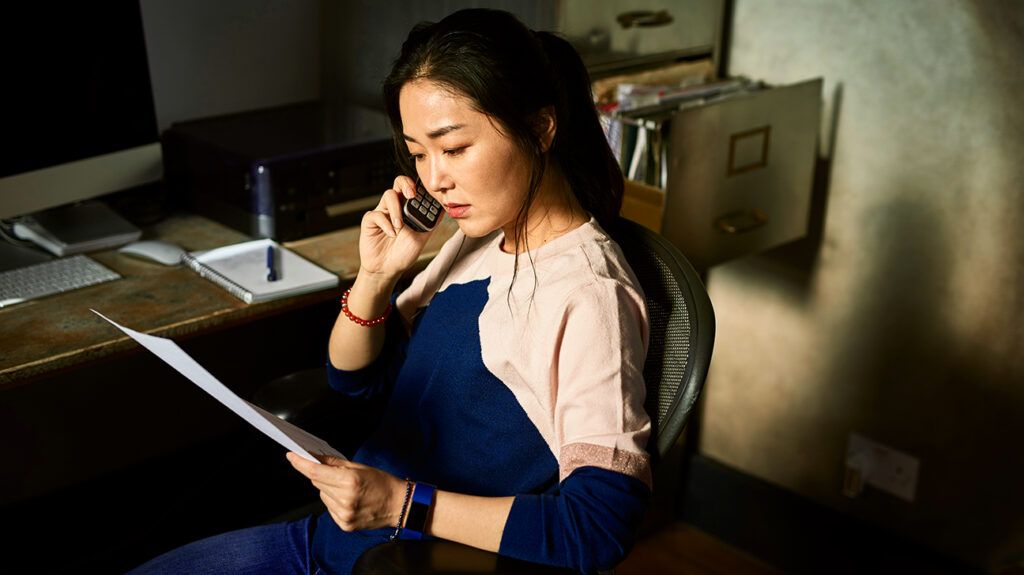 Woman on the phone trying to pay a bill dealing with debt depression