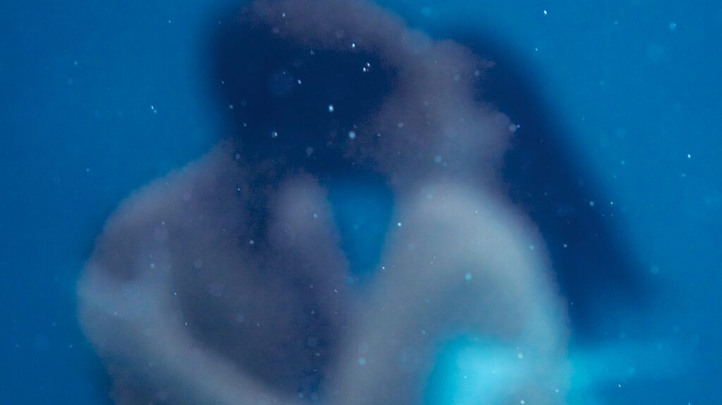 Couple kissing under water