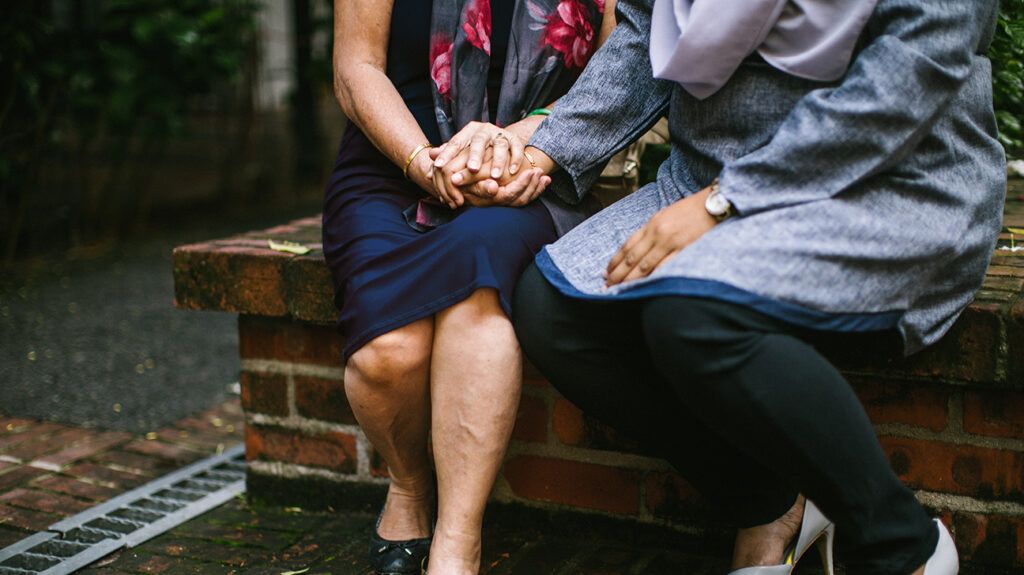 Two women giving each other support during grieving process