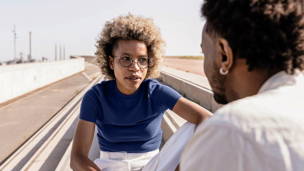 Young Black woman talking to her partner