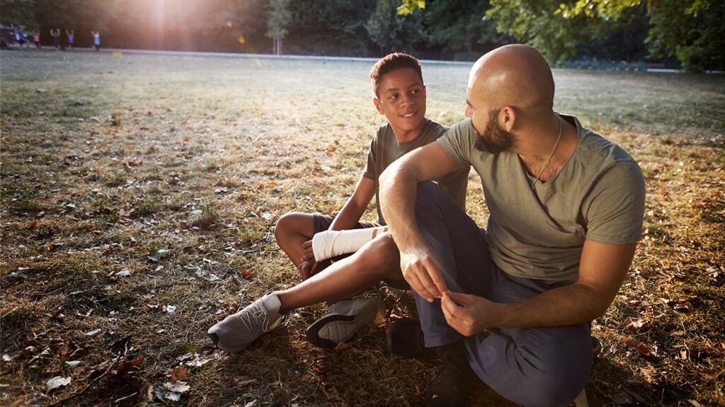 https://media.post.rvohealth.io/wp-content/uploads/sites/4/2021/08/father-son-talking-sitting-in-park-outdoors-nature-1296x728-header-1024x575.jpg